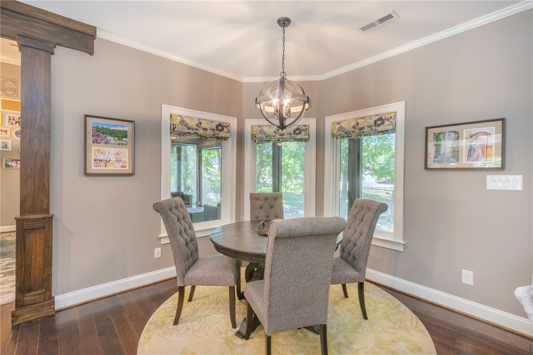 4420 Denver Cove Road Anderson, SC 29625 - Photo 14 of 50 This dining area features hardwood floors, crown molding, and a unique spherical chandelier.