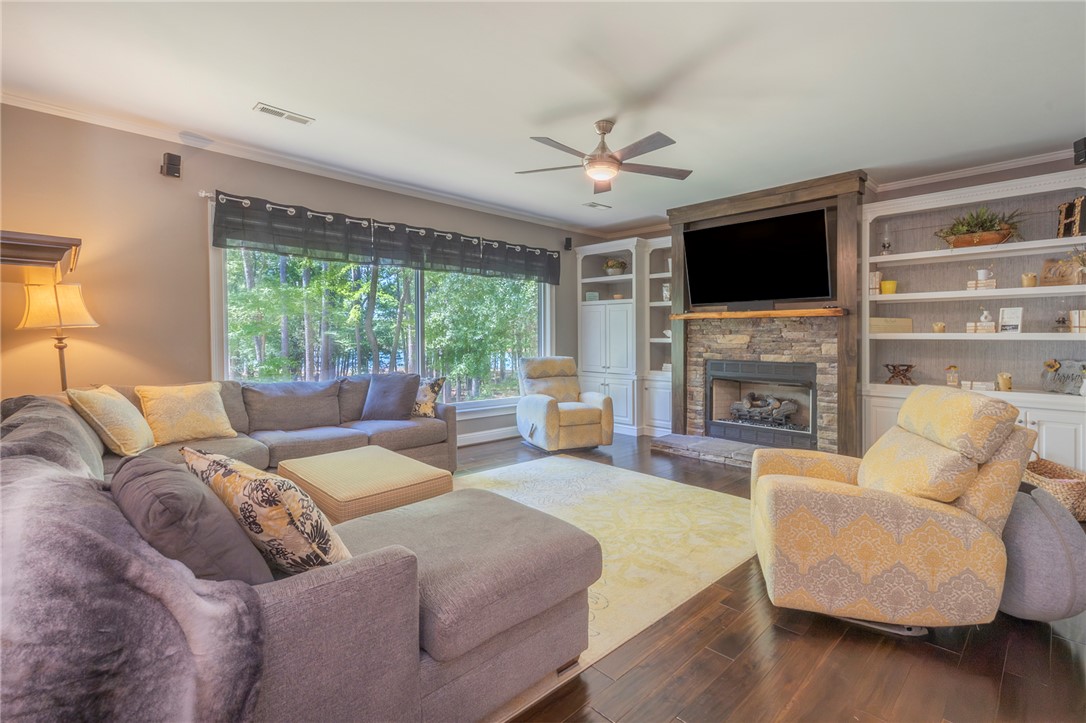 4420 Denver Cove Road Anderson, SC 29625 - Photo 15 of 50 This inviting living room showcases a beautiful fireplace and ample built-in shelving, perfect for comfortable living.