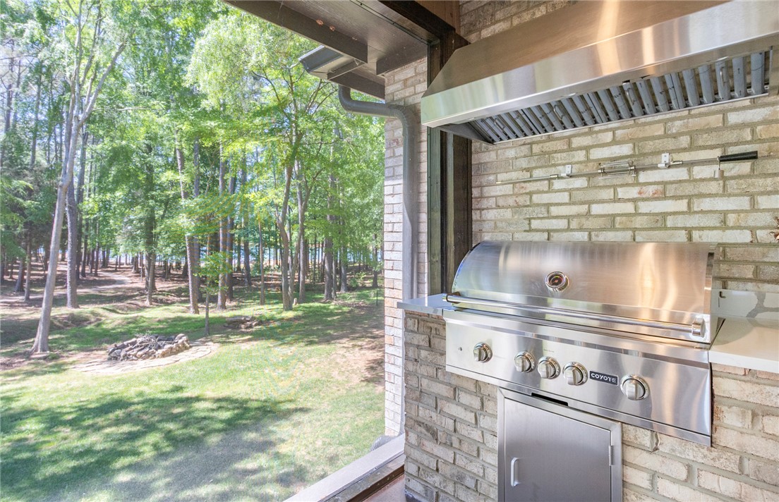 4420 Denver Cove Road Anderson, SC 29625 - Photo 21 of 50 This inviting outdoor space features an outdoor kitchen perfect for entertaining amidst a verdant backdrop.
