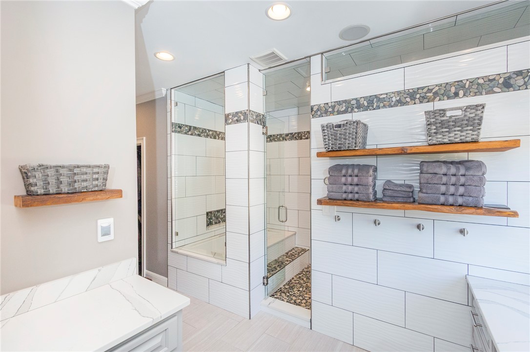 4420 Denver Cove Road Anderson, SC 29625 - Photo 29 of 50 This spacious bathroom offers a clean aesthetic with modern fixtures and smart storage solutions.