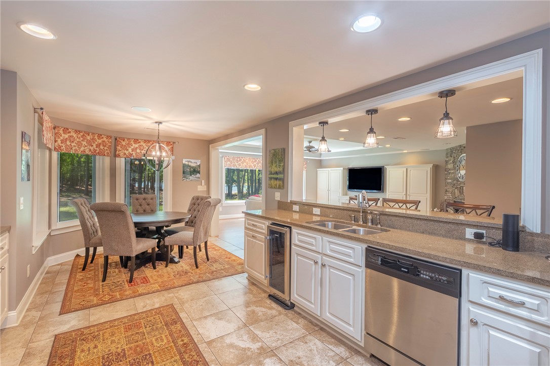 4420 Denver Cove Road Anderson, SC 29625 - Photo 50 of 50 This kitchen and dining area features granite counters and an open floorplan, creating an inviting space.