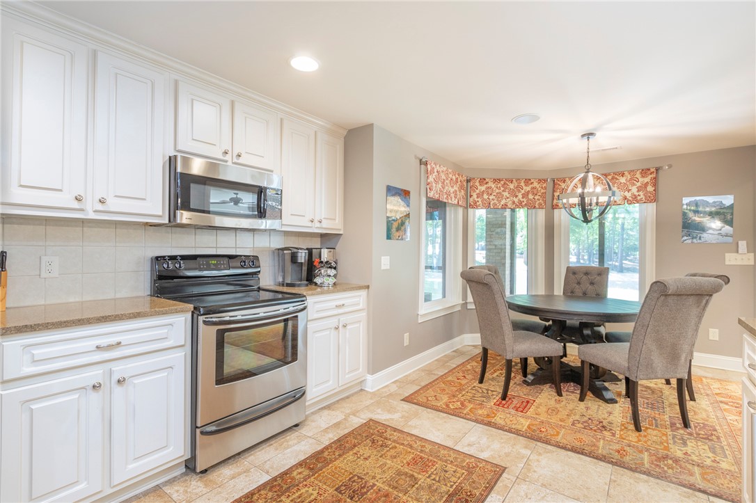 4420 Denver Cove Road Anderson, SC 29625 - Photo 34 of 50 This bright kitchen features modern appliances and a charming breakfast area, perfect for everyday living.