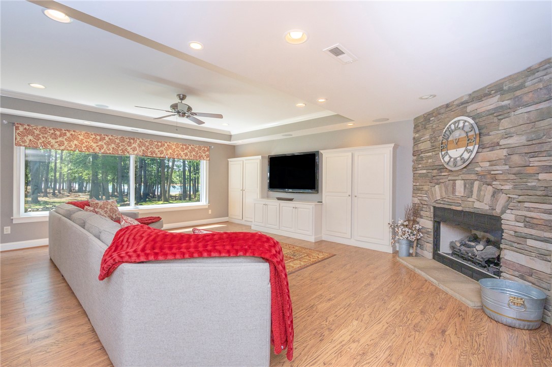 4420 Denver Cove Road Anderson, SC 29625 - Photo 35 of 50 This inviting living area boasts a rustic fireplace and expansive windows with serene views.