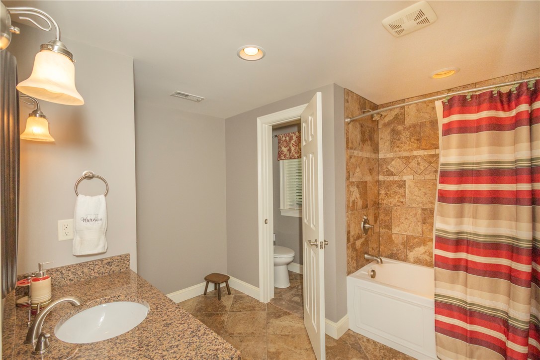 4420 Denver Cove Road Anderson, SC 29625 - Photo 38 of 50 This bath features a spacious vanity and a combination shower and tub with tile surround.