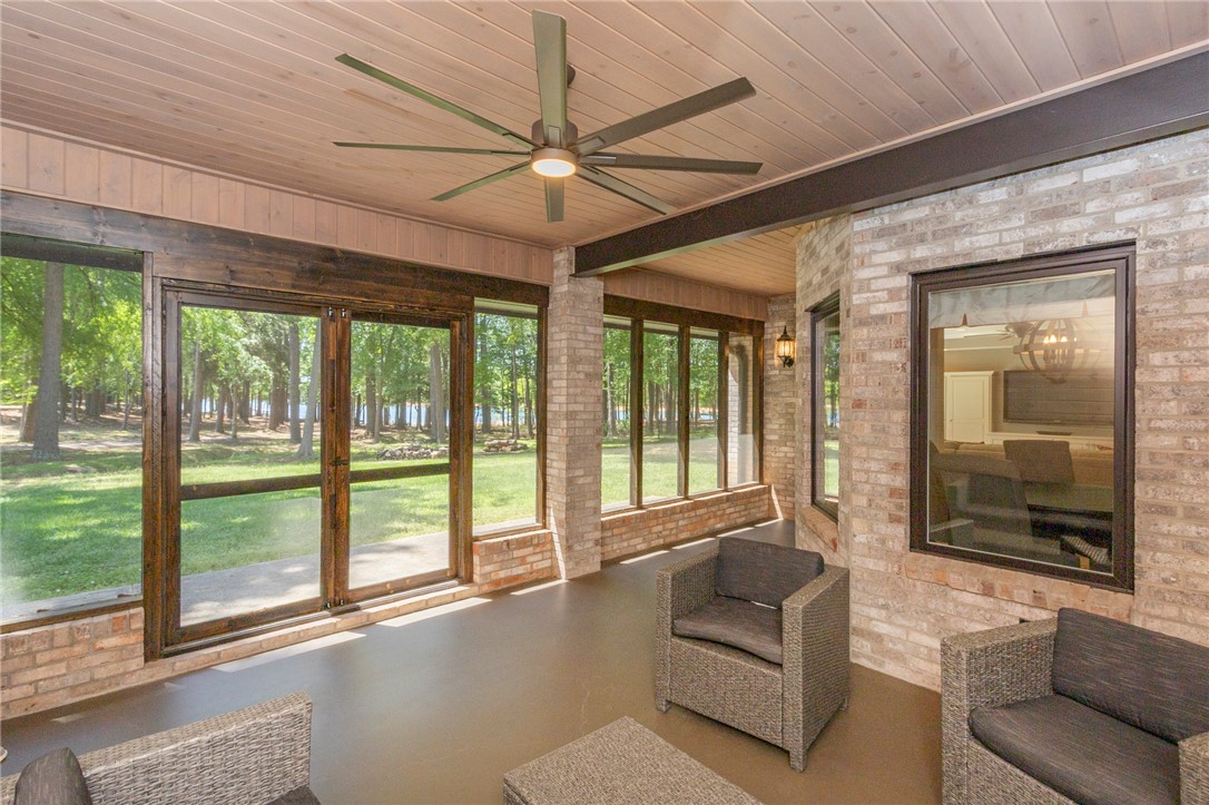 4420 Denver Cove Road Anderson, SC 29625 - Photo 39 of 50 This inviting porch offers tranquil views of lush greenery and distant waters.