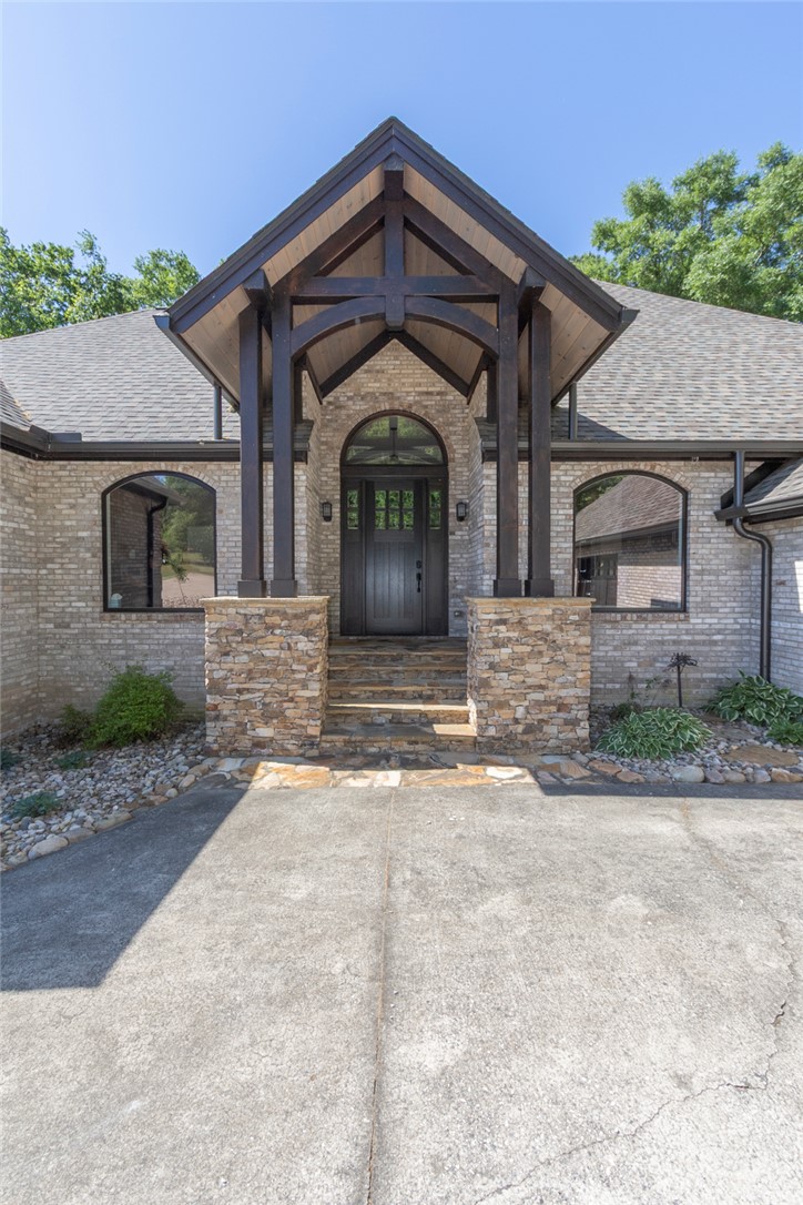 4420 Denver Cove Road Anderson, SC 29625 - Photo 4 of 50 The striking facade welcomes with rich textures and a grand entrance.