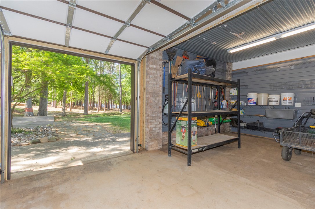 4420 Denver Cove Road Anderson, SC 29625 - Photo 46 of 50 This versatile garage space seamlessly connects indoors with a lush, green outdoor landscape.