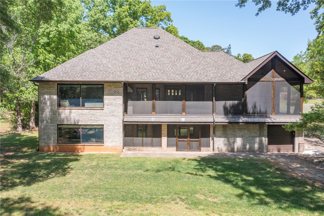 4420 Denver Cove Road Anderson, SC 29625 - Photo 49 of 50 This spacious brick home features multiple windows and a screened-in porch, perfect for enjoying the surroundings.