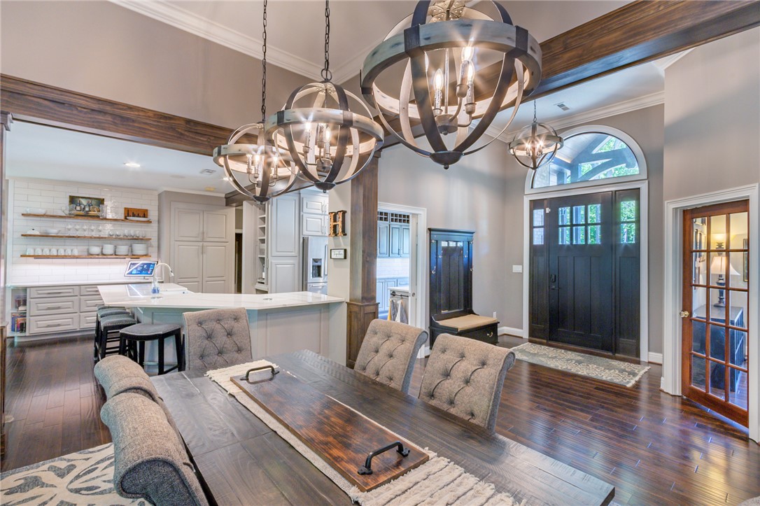 4420 Denver Cove Road Anderson, SC 29625 - Photo 6 of 50 This open concept space features rich wood flooring, elegant chandeliers, and ample natural light.