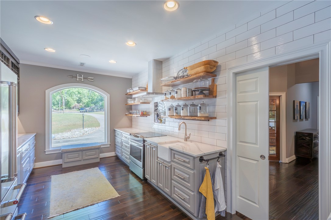 4420 Denver Cove Road Anderson, SC 29625 - Photo 10 of 50 This spacious kitchen offers ample counter space, rich wood floors, and a bright, airy ambiance.