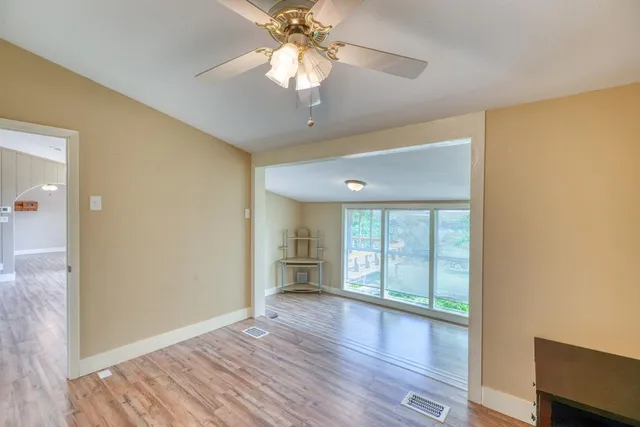 wooden floor in an empty room with a window