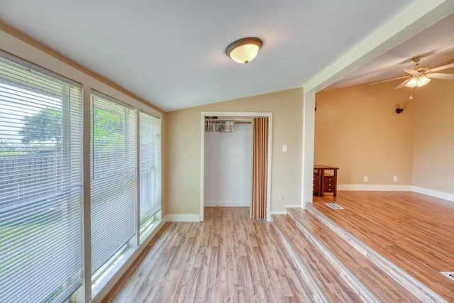 a view of a room with wooden floor and window