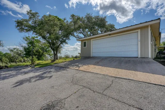a view of a house with a yard and garage