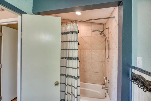 a bathroom with a glass shower door