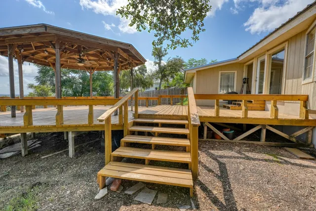 a view of a house with backyard and sitting area