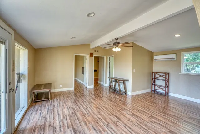 a view of a room with wooden floor and furniture