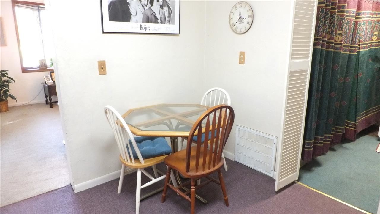 2122-24 Rivington Road Loves Park, IL 61111 - Photo 8 of 22 a view of a dining room with furniture and wooden floor