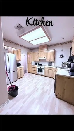 a view of a living room and a kitchen with a sink