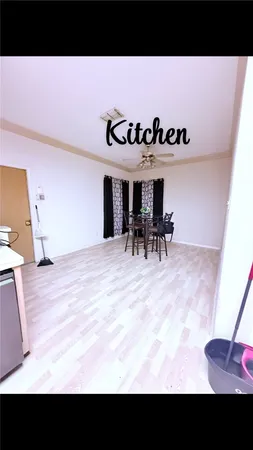 a view of a dining room with furniture and a kitchen