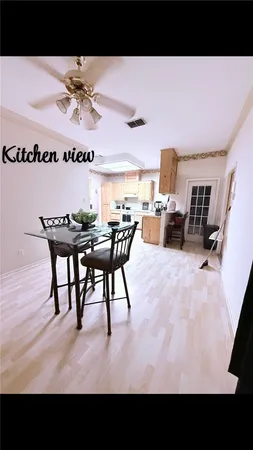 a view of a living room and kitchen with furniture
