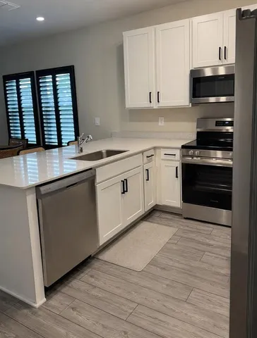 a kitchen with stainless steel appliances granite countertop a stove and a sink