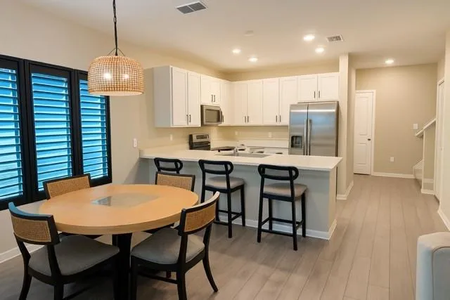 a view of a dining room with furniture and wooden floor