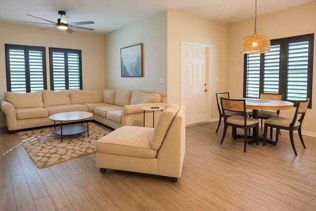a living room with furniture and a wooden floor