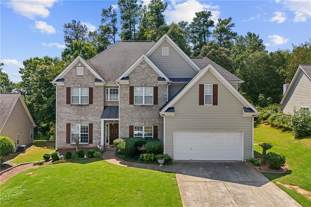 a front view of a house with a yard and garage