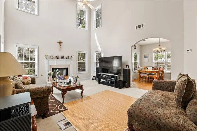 a living room with furniture a fireplace and a flat screen tv
