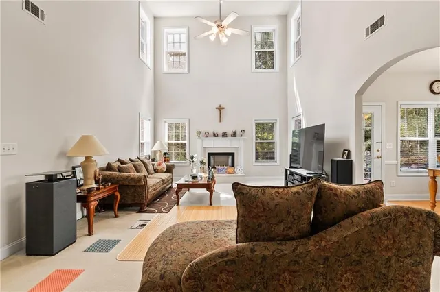 a living room with furniture fireplace and a chandelier