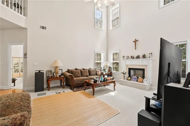 a living room with furniture a fireplace and a flat screen tv