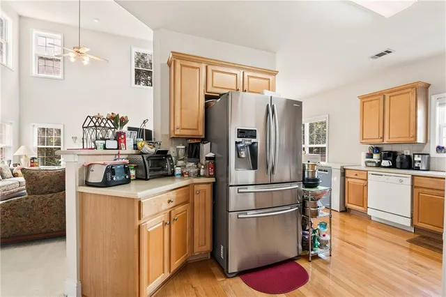 a dining room with furniture a chandelier and wooden floor