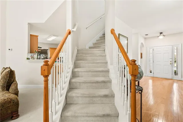 a spacious bedroom with a bed and a chandelier