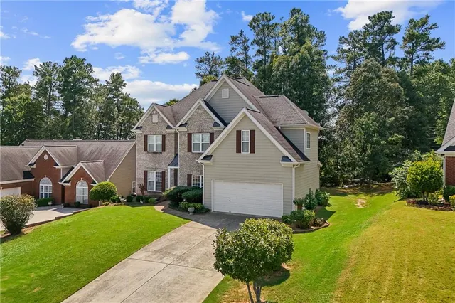 a house with green field in front of it