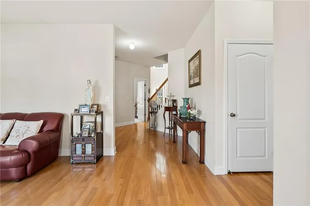 a hallway with wooden floor table and chairs