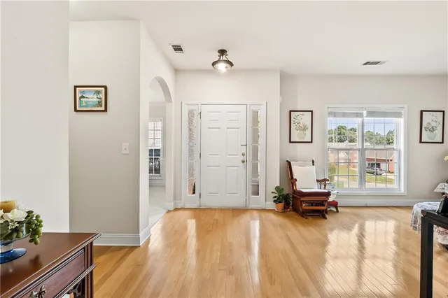 a living room with a bed furniture and a window