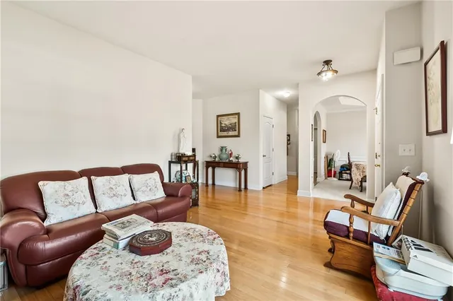 a living room with furniture rug and a mirror