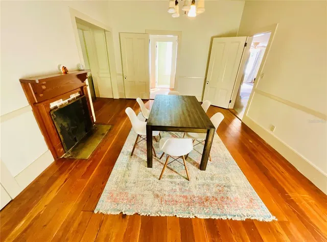 a view of a kitchen with stainless steel appliances wooden floor and a window