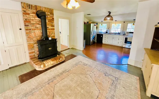 a kitchen with stainless steel appliances a refrigerator sink and white cabinets
