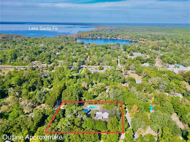 a view of a house with pool yard and a yard