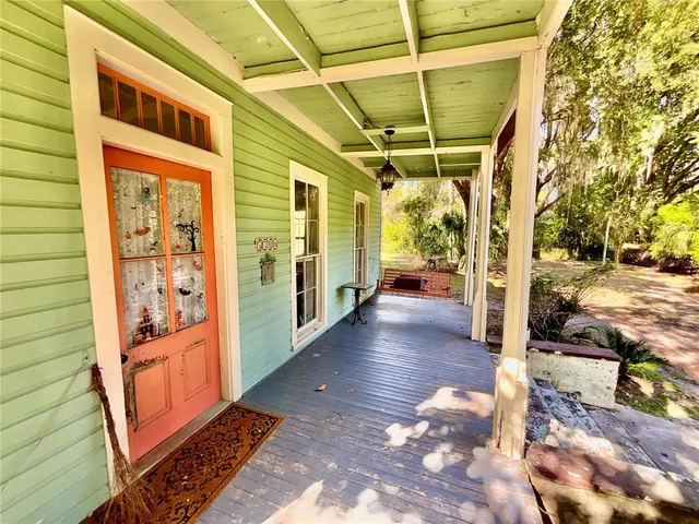 a view of a porch with wooden floor and stairs
