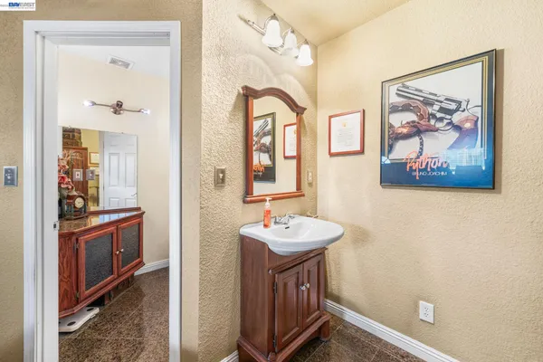a bathroom with a sink mirror and vanity