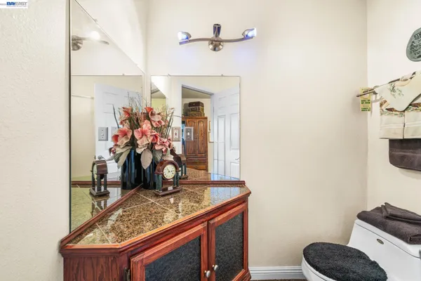 a view of bathroom with a sink and mirror