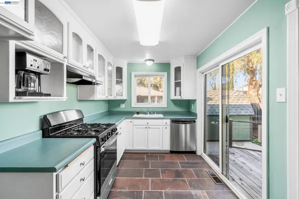 a kitchen with a stove a sink and a refrigerator