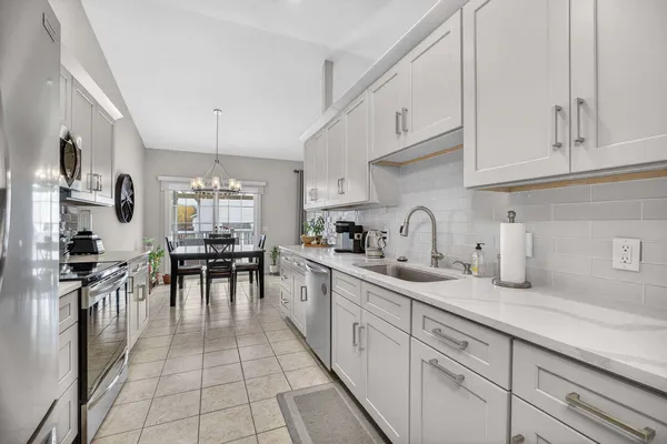 a bathroom with a sink toilet a mirror and shower curtain