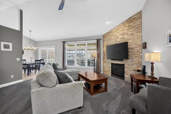 a living room with furniture a fireplace and a flat screen tv