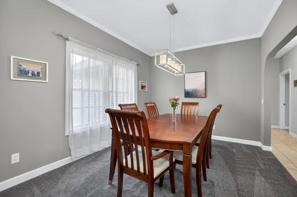 a view of a dining room with furniture and chandelier