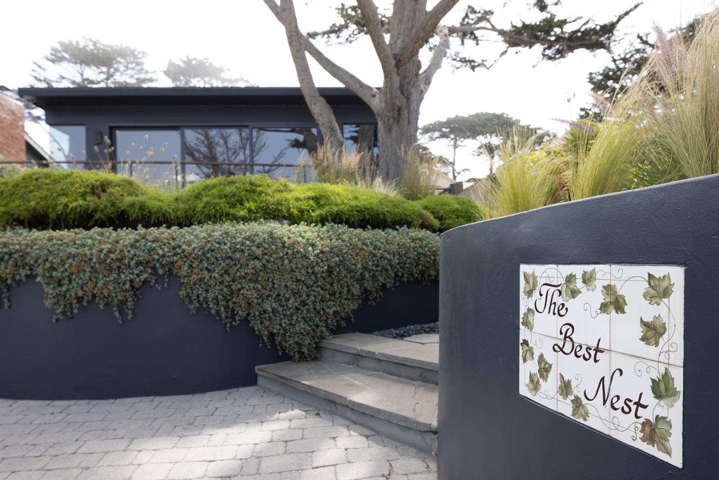 0 Scenic & 10th Corner Carmel, CA 93923 - Photo 4 of 23 a front view of a house with a yard and garage