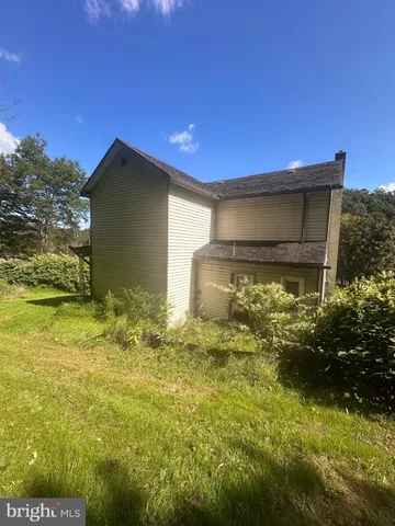 a backyard of a house with yard and outdoor seating
