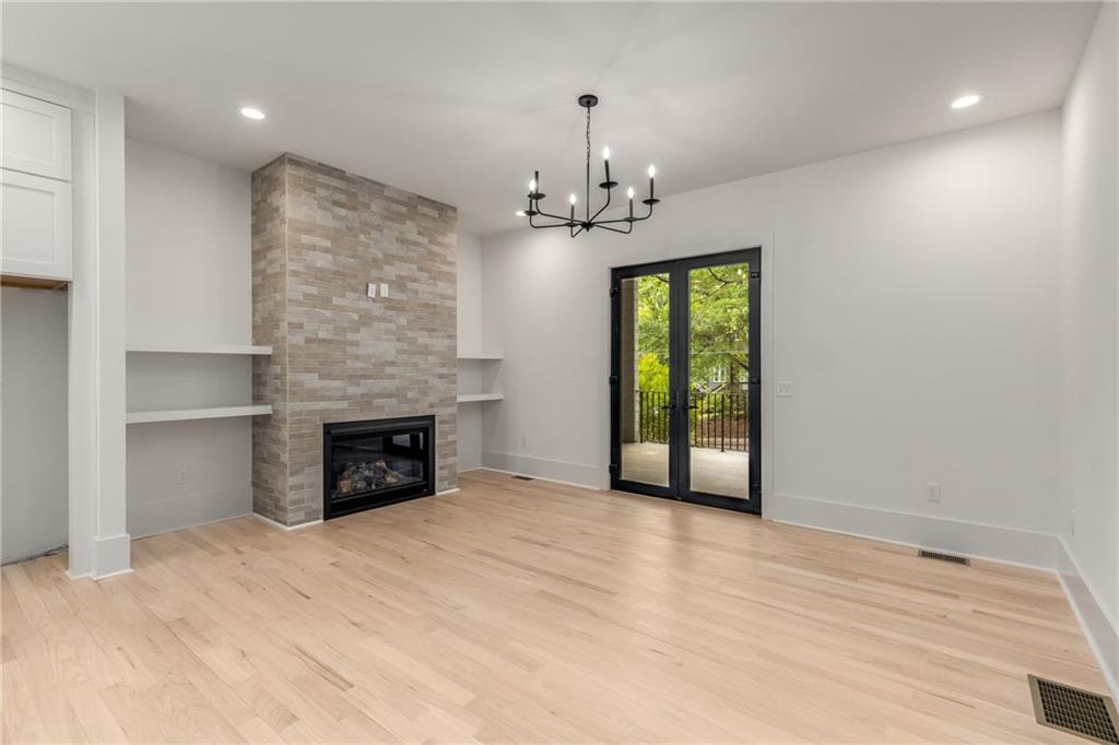 628 Robinson Avenue Southeast, Unit B Atlanta, GA 30312 - Photo 12 of 77 a view of an empty room with a fireplace and a window